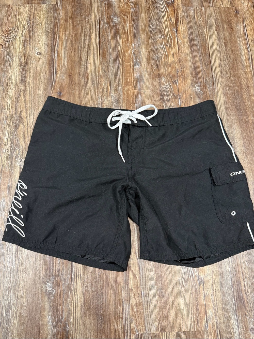 Y2K O'Neill black board shorts with white 'O'Neill' script logo on the side